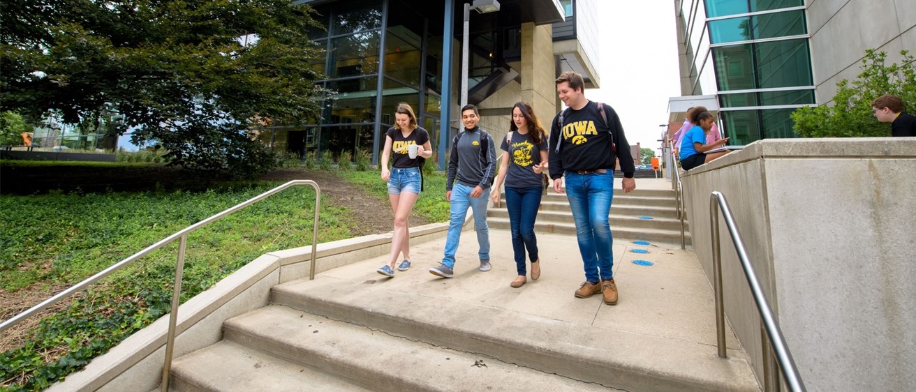 Fours students walking path on campus