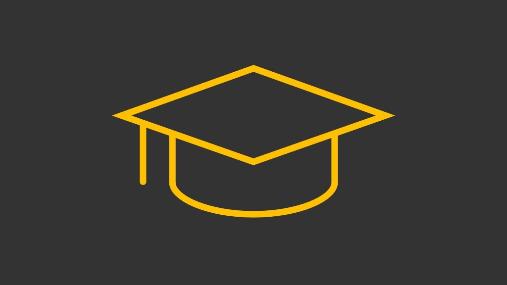 gold graduation cap on dark gray background